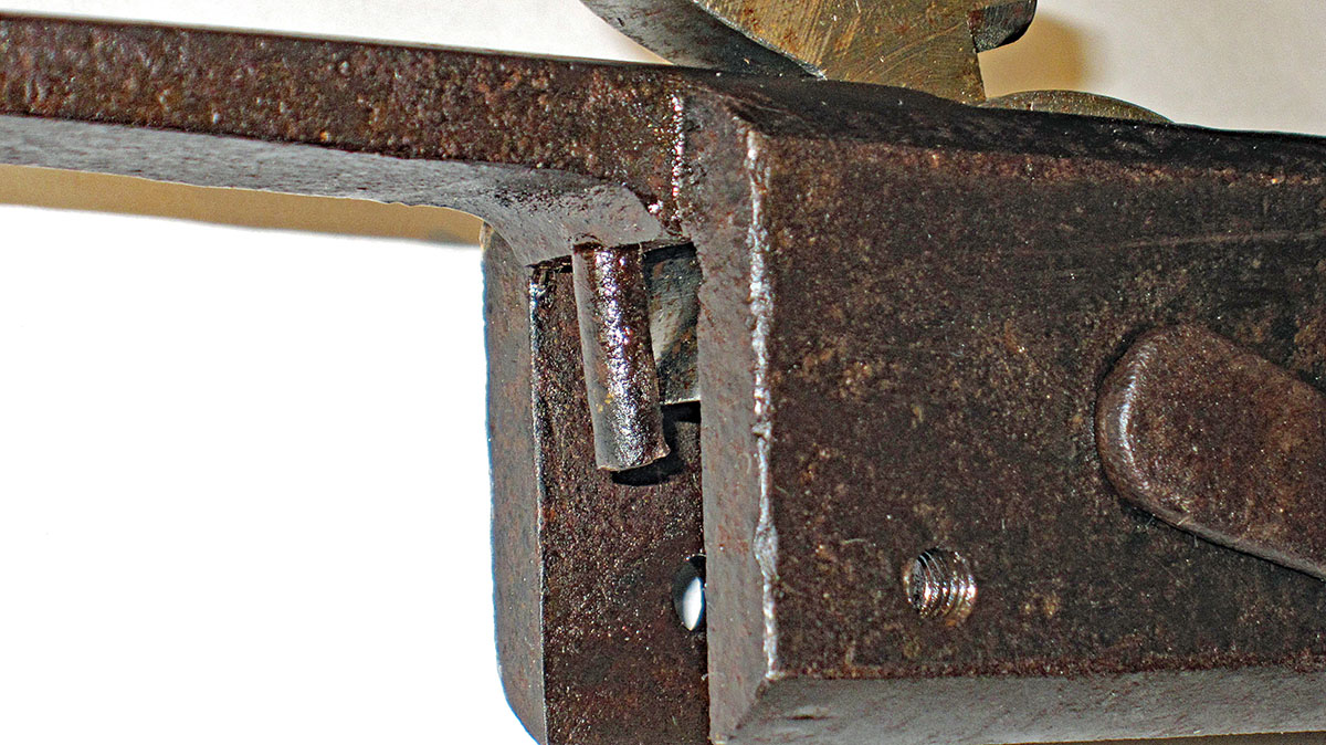 Bent stud touching the rear of the hammer.